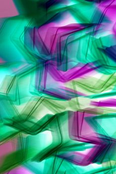 Dynamic abstract image featuring colorful light patterns in motion, creating a vivid visual effect.