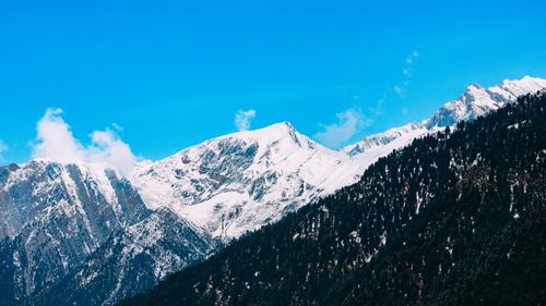 Free Breathtaking view of snow-covered mountains against a clear blue sky. Stock Photo