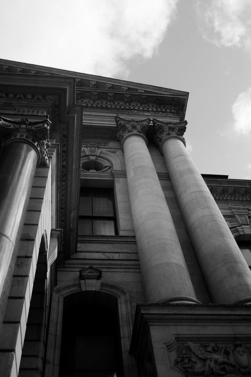 Free Black and white architectural photography capturing ornate columns and classic design. Stock Photo