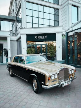 Classic luxury car parked outside the elegant Queen Residence.
