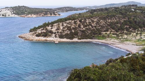 Free A beautiful coastal view with azure waters and rocky landscape, perfect for travel and nature themes. Stock Photo
