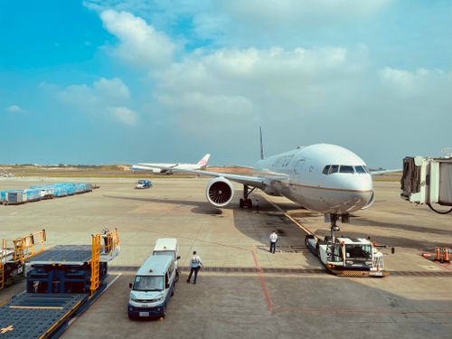 Free Boeing 777 airplane at Taiwan's Taoyuan International Airport gate with ground crew preparing for departure. Stock Photo