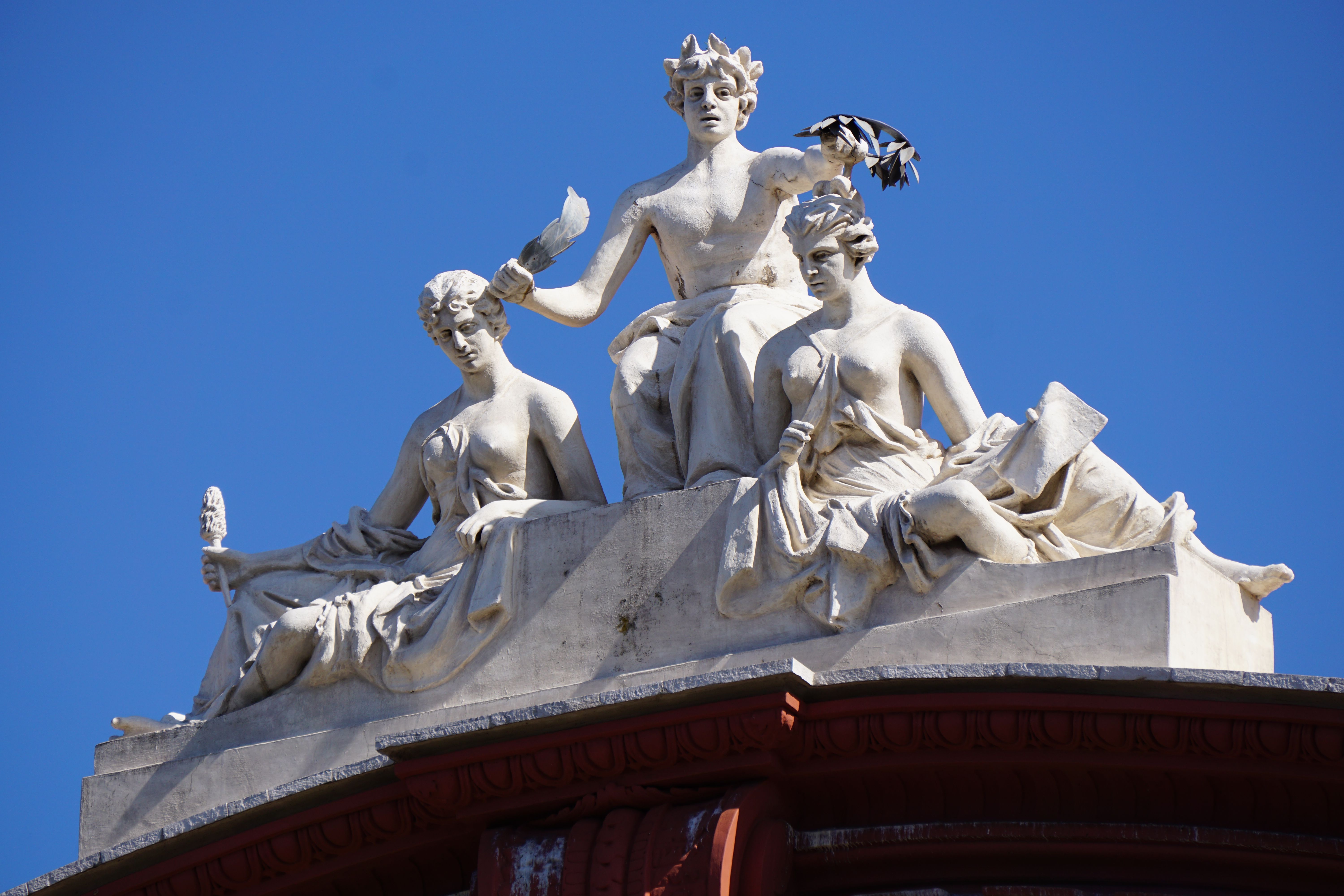 Close-up of artistic sculptures on a historic building in Bari, Italy, under a clear blue sky. - Bari