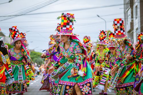 Free Colorful traditional costumes at a lively outdoor cultural parade with dancers in vibrant attire. Stock Photo