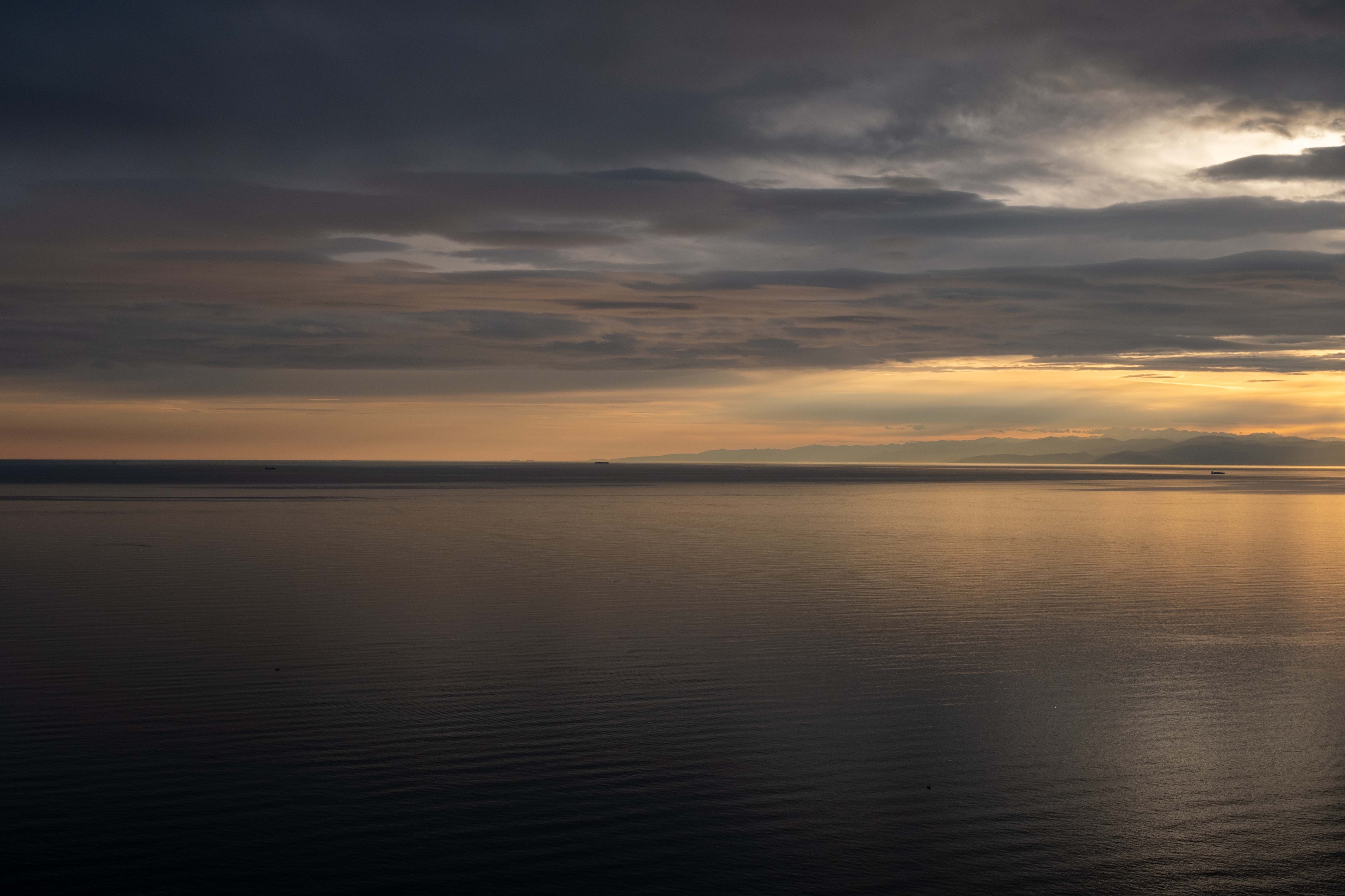 A serene coastal view of Ho with morning light over calm water