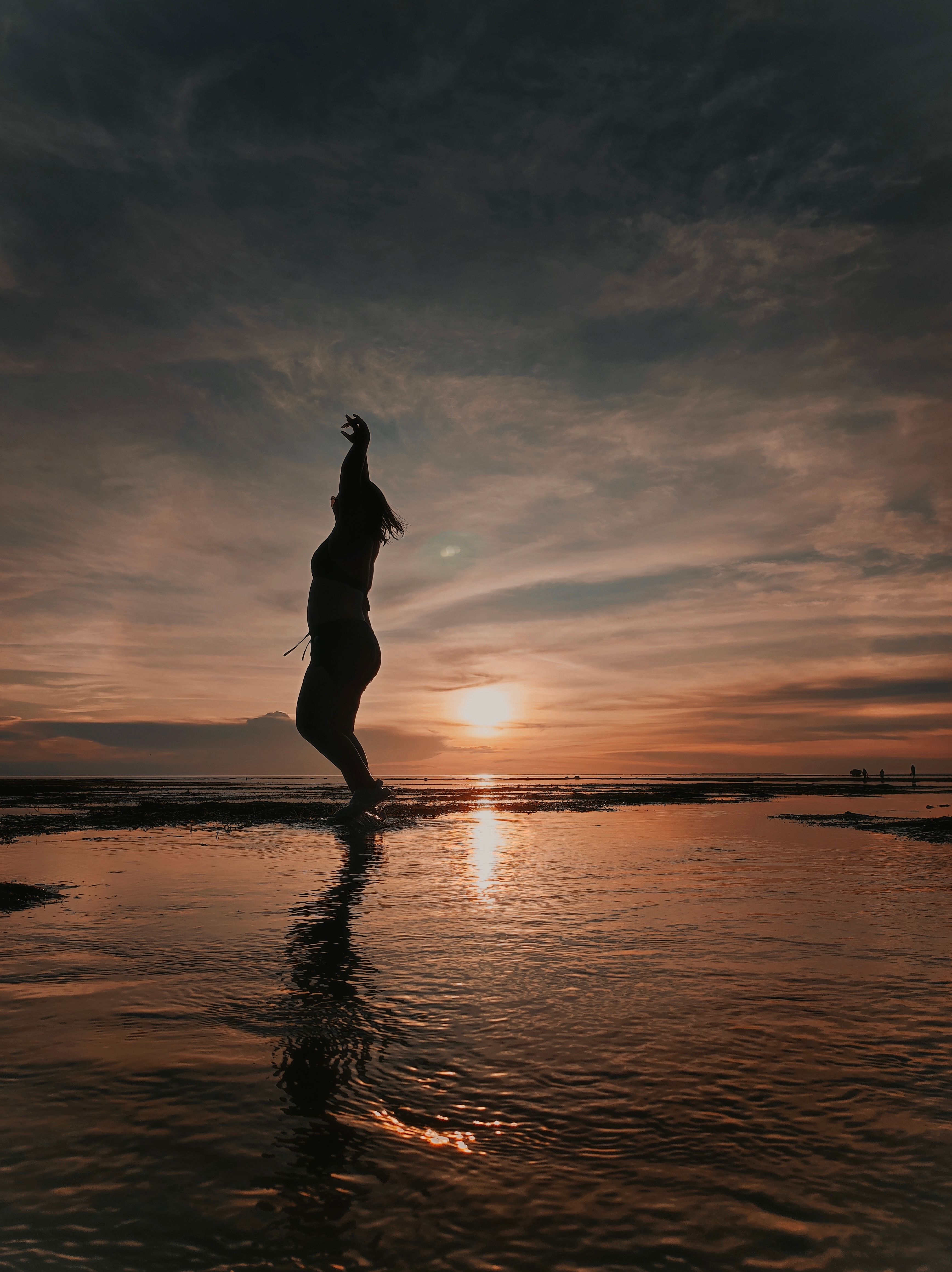 Silhouette of Woman Dancing on Beach at Sunset · Free Stock Photo