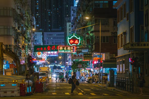 Free People Crossing Street during Nighttime Stock Photo