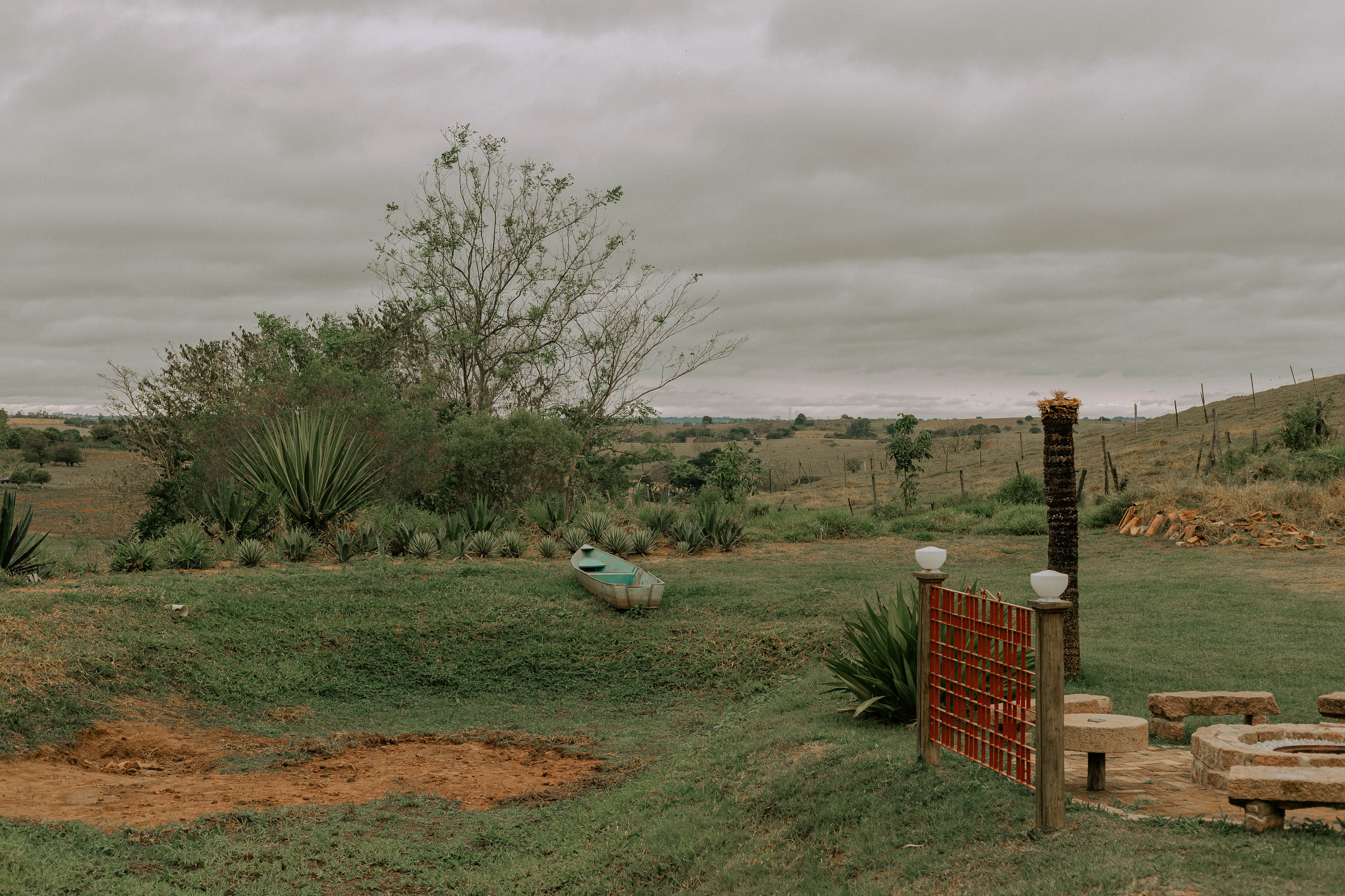 Serene rural scene featuring a canoe and green landscape in Presidente Prudente, Brazil.
