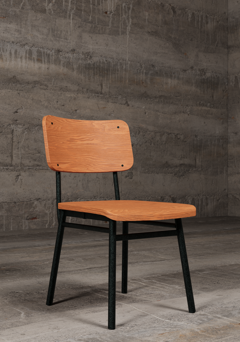 Wooden chair with metal legs in an industrial setting