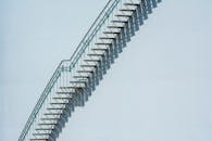 Abstract Industrial Stairs on White Building Exterior