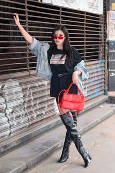 Chic street style featuring red accents with a trendy urban backdrop.