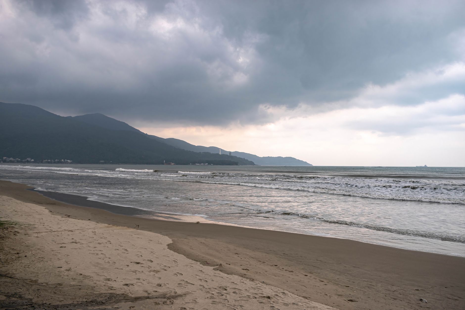 Dramatic cloudy beach scene in Da Nang, highlighting the coast and sea under a moody sky.