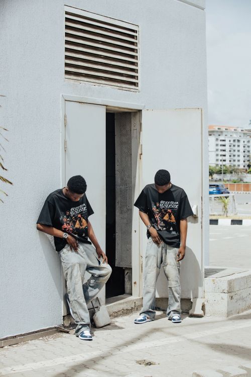 Free Two men in matching outfits pose outside a building, showcasing urban fashion. Stock Photo