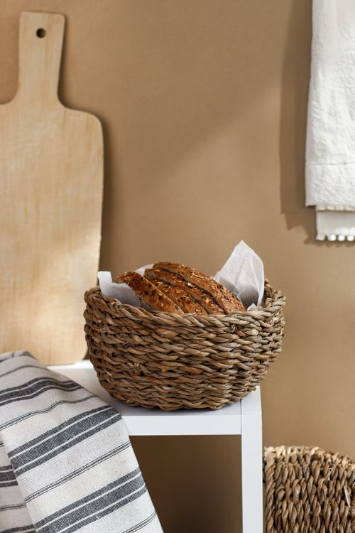 Free Freshly baked bread in a wicker basket on a kitchen counter with rustic decor. Stock Photo