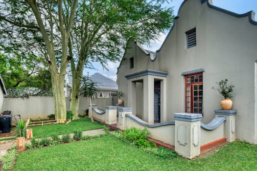 Lovely Art Deco-style house with a well-maintained garden in a suburban setting.
