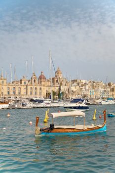 A picturesque view of boats and historic architecture in Birgu, Malta's harbor.