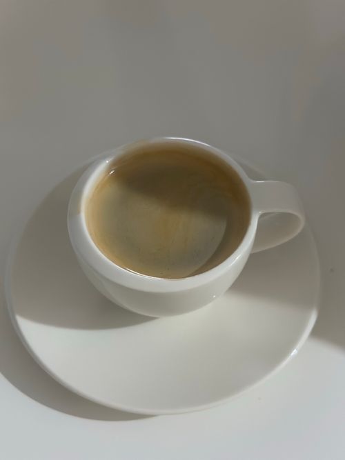 Free Top view of a white coffee cup with espresso, casting a gentle shadow. Stock Photo