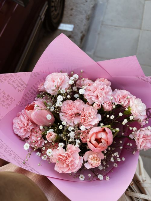 Free A lovely bouquet of pink carnations and tulips adorned with baby's breath. Stock Photo