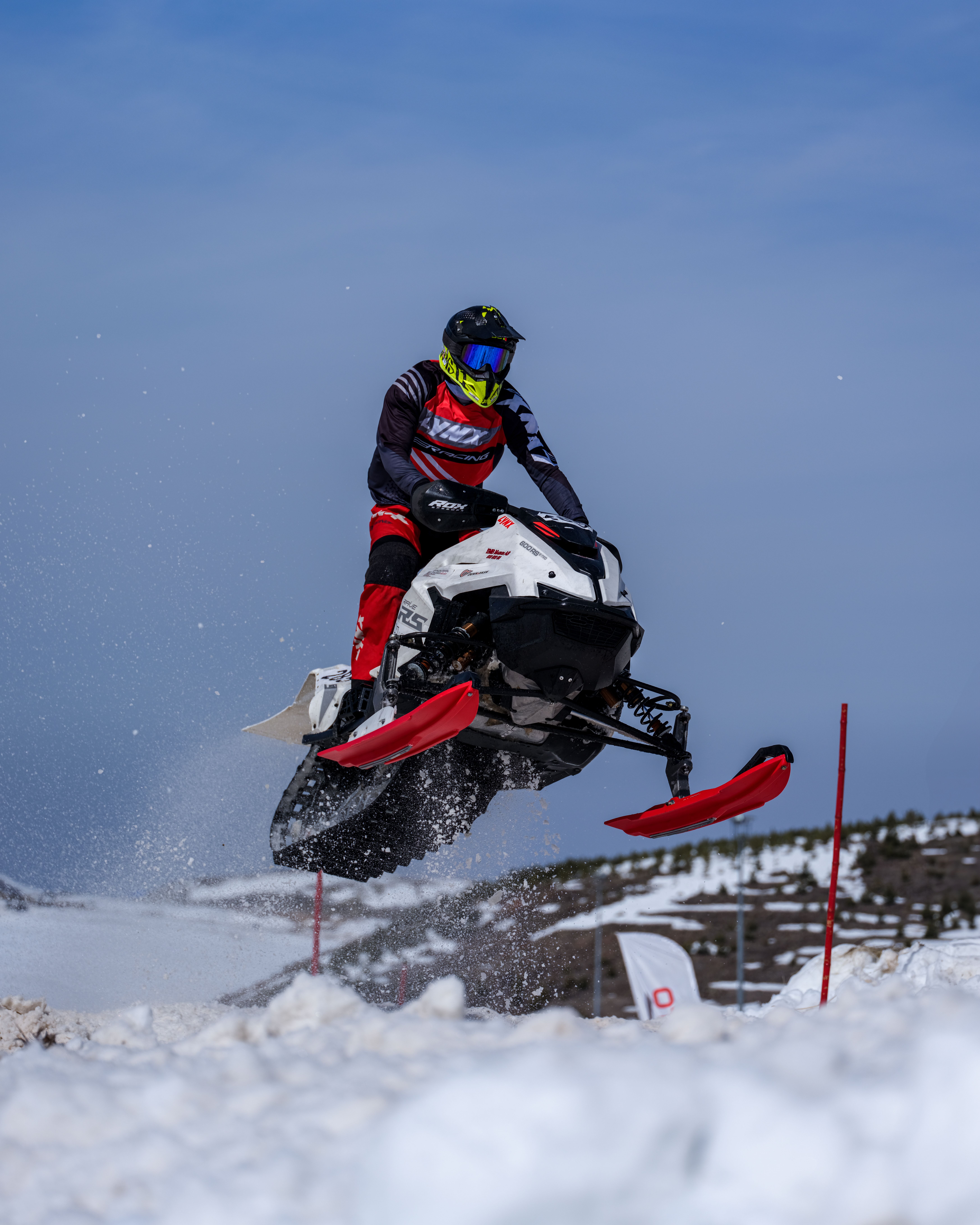 Snowmobile Jumping Over Snowy Terrain · Free Stock Photo