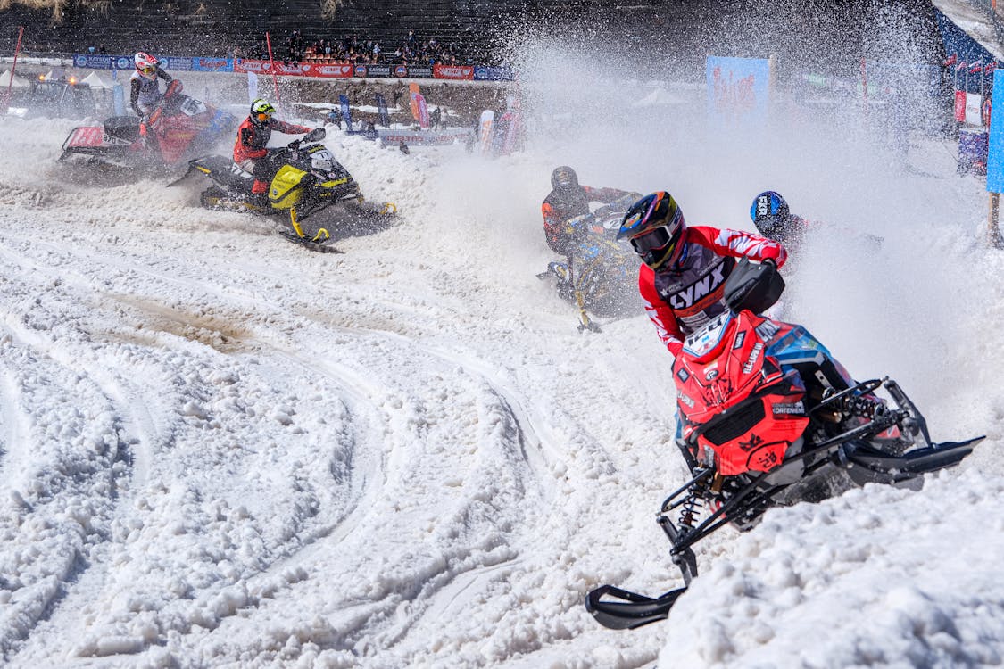 Thrilling Snowmobile Race on Snowy Track · Free Stock Photo