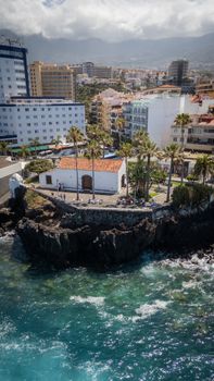Scenic aerial view of Nuestra Señora de la Peña Church on a volcanic cliff in Puerto de la Cruz, Tenerife.