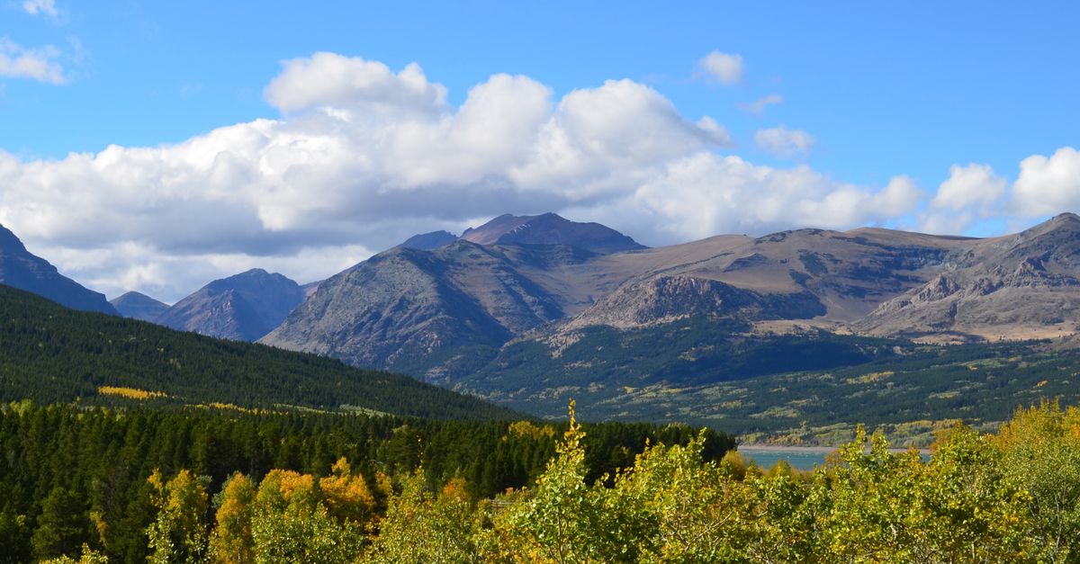 Beautiful mountain landscape in Montana with vibrant fall foliage and expansive sky.