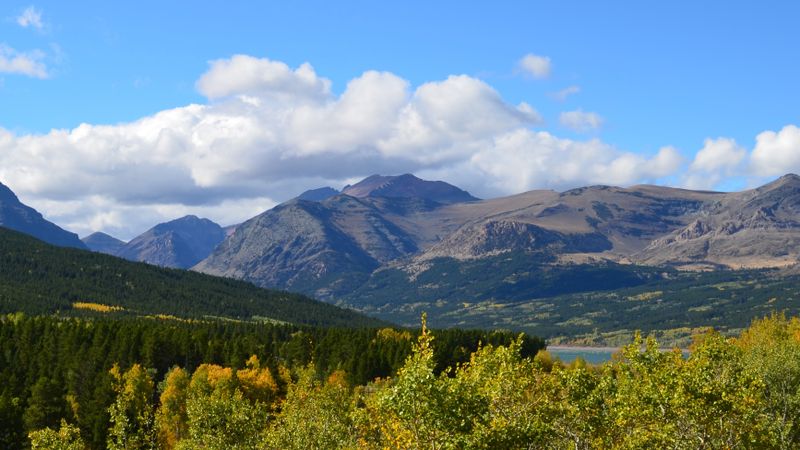 Beautiful mountain landscape in Montana with vibrant fall foliage and expansive sky.