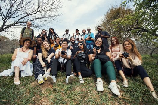 A diverse group of photographers gathered outdoors, capturing the synergy in nature.