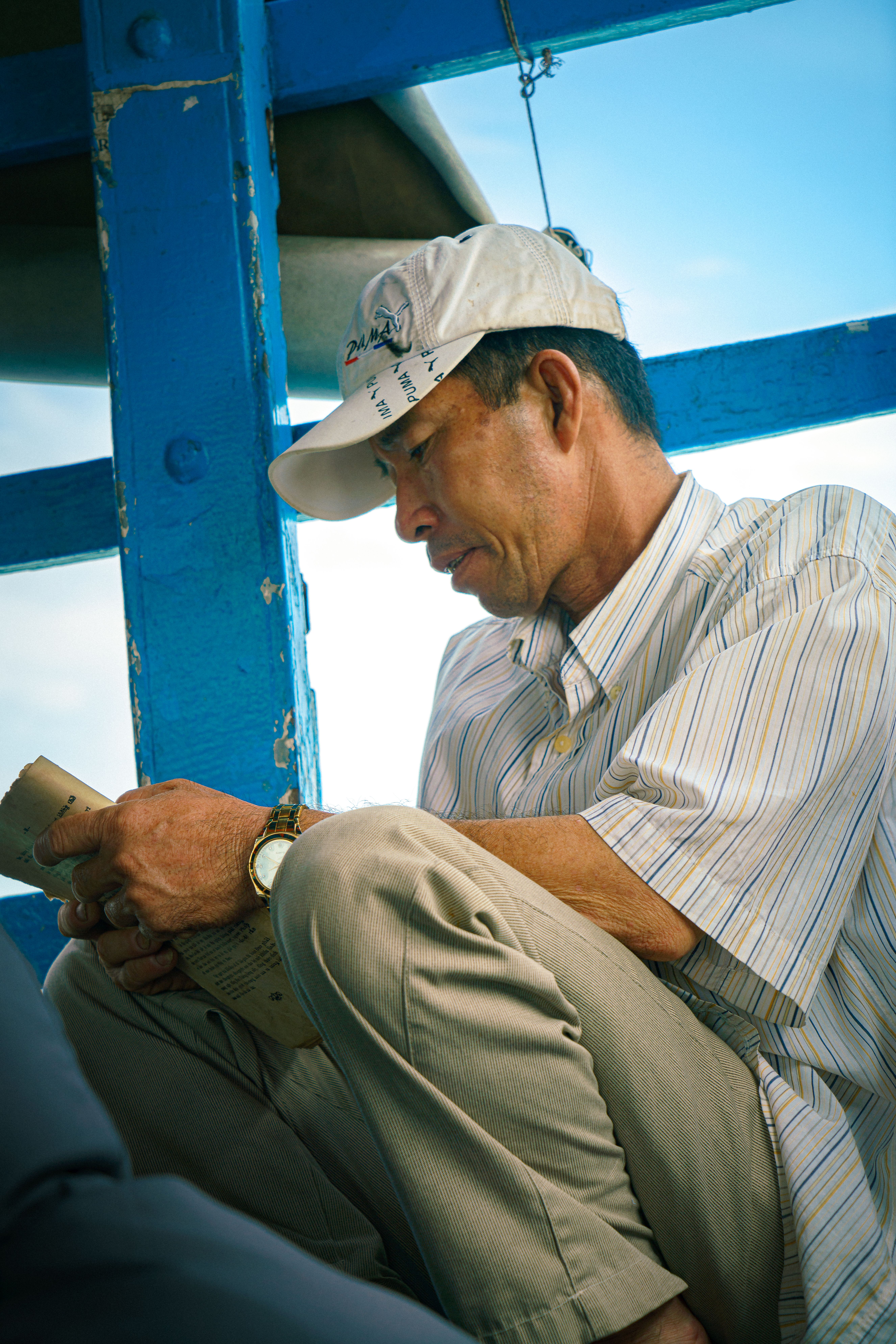 Vietnamese Man Reading on a Boat in Ho Chi Minh City · Free Stock Photo