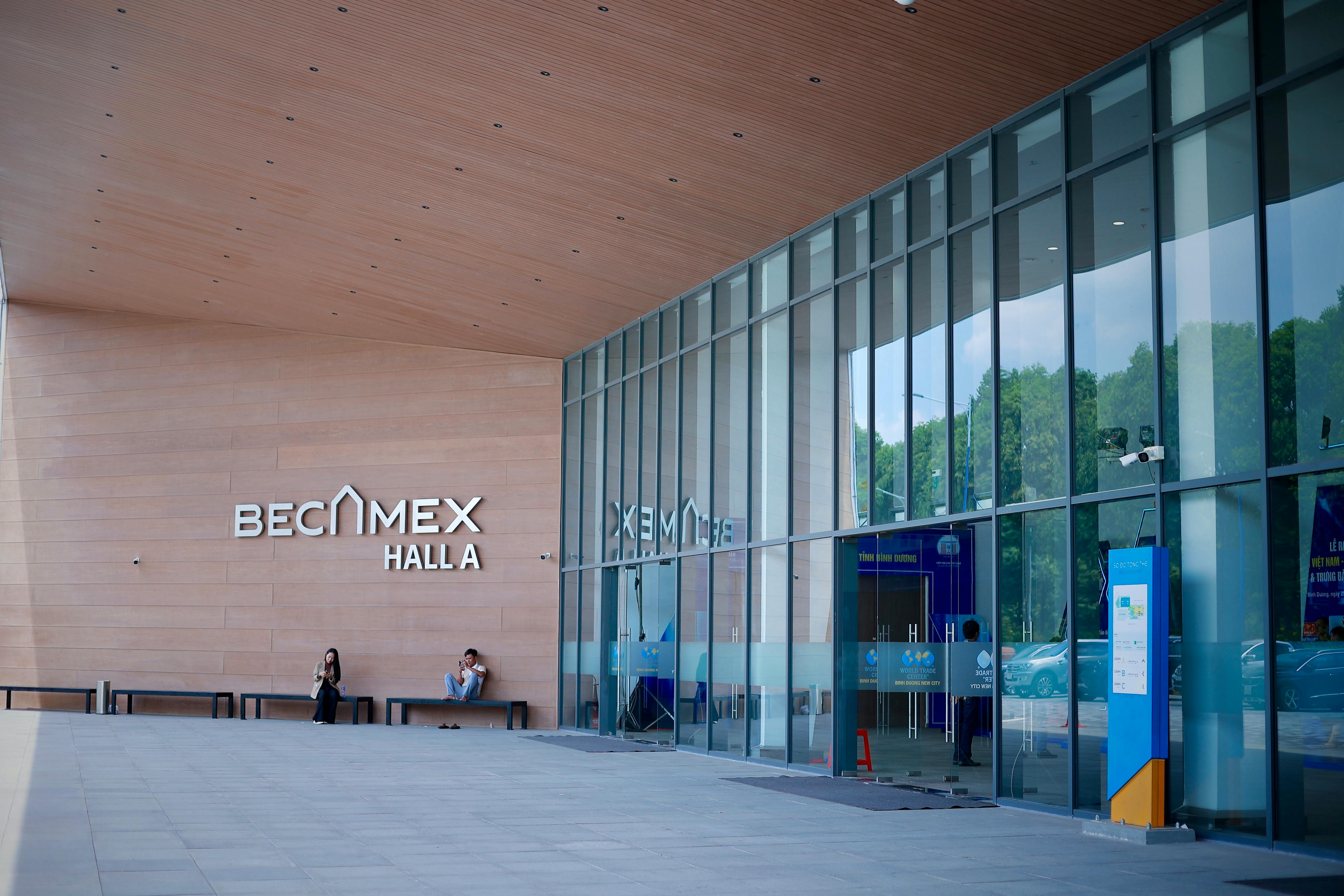 Conference hall display wall with company logos and job postings in a city background