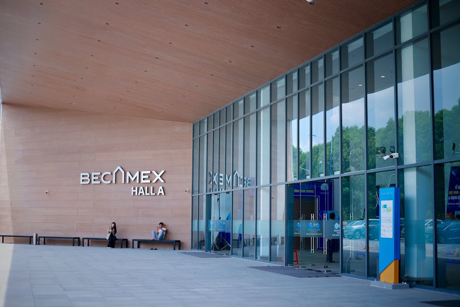 Conference hall display wall with company logos and job postings in a city background