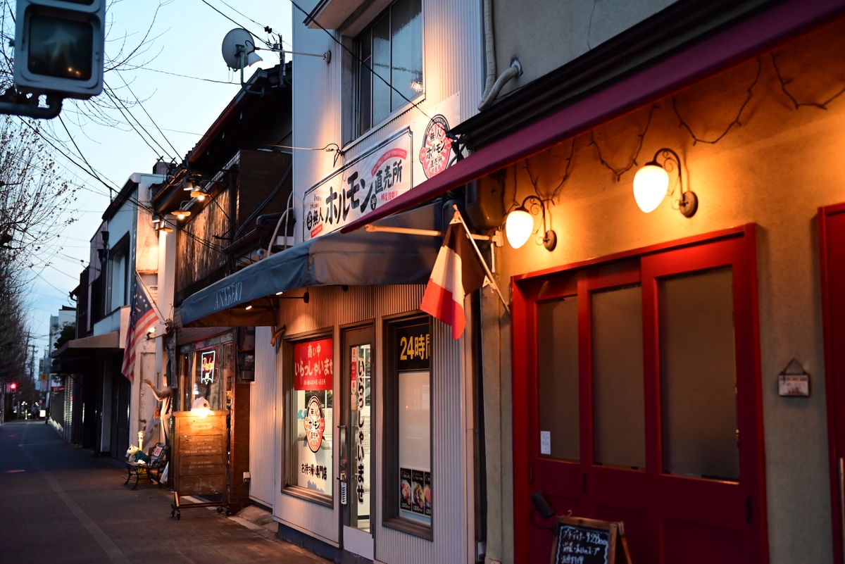 A small restaurant storefront lit warmly at night.