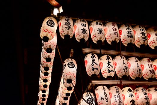 A captivating display of illuminated traditional Japanese lanterns at night, showcasing cultural artistry.