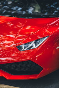 Close-up of a red Lamborghini Huracan parked on a street in New Delhi, India.