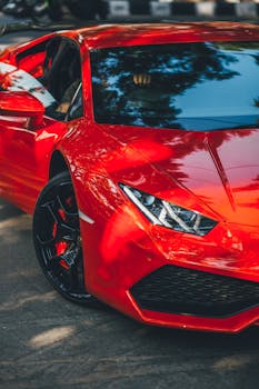 A vibrant red Lamborghini Huracan supercar parked on an Indian road, showcasing luxury and performance.