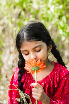Portrait of a girl holding a flower