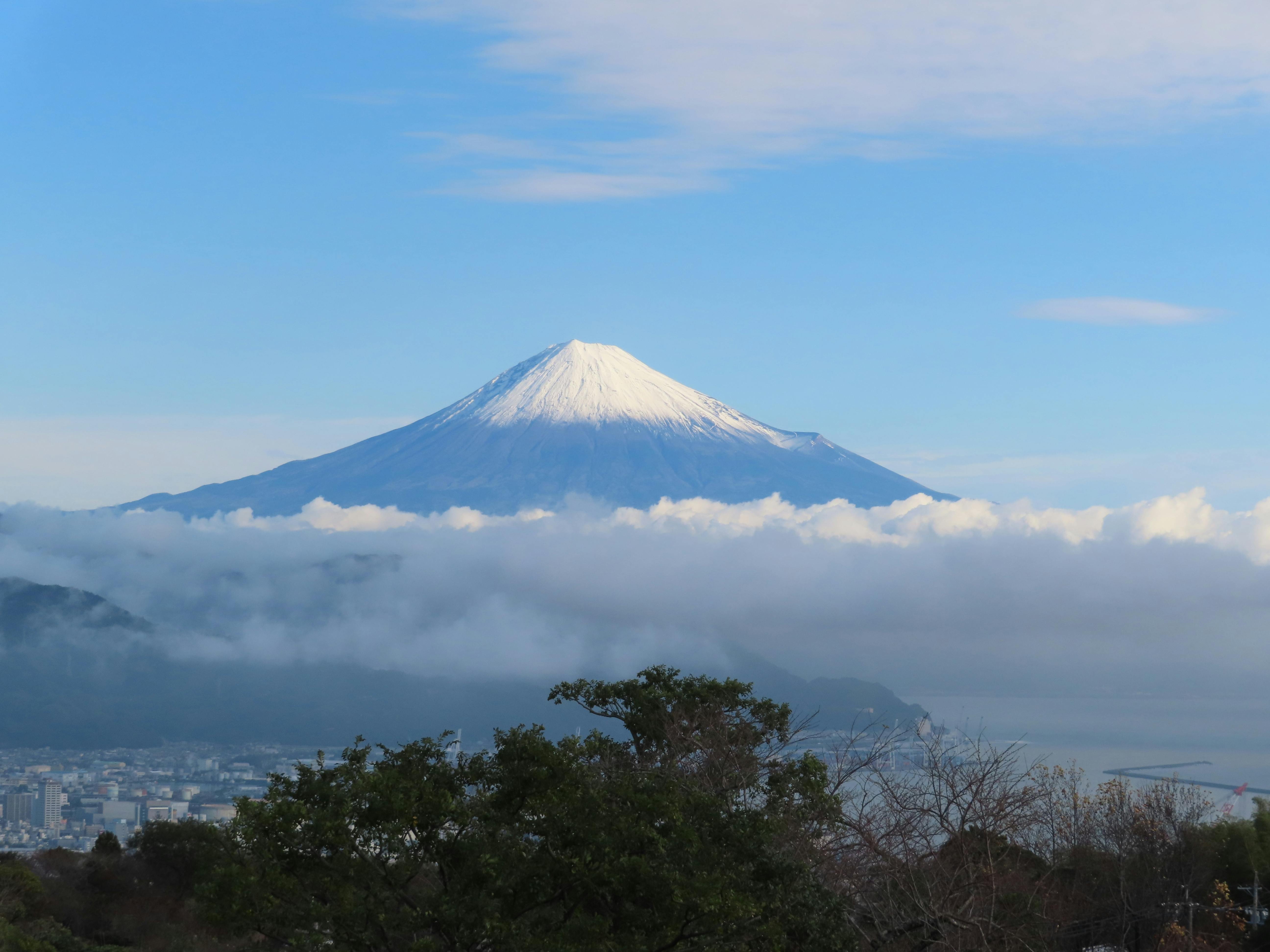 Fuji-Q Highland amusement park with Mount Fuji towering in the background at sunset