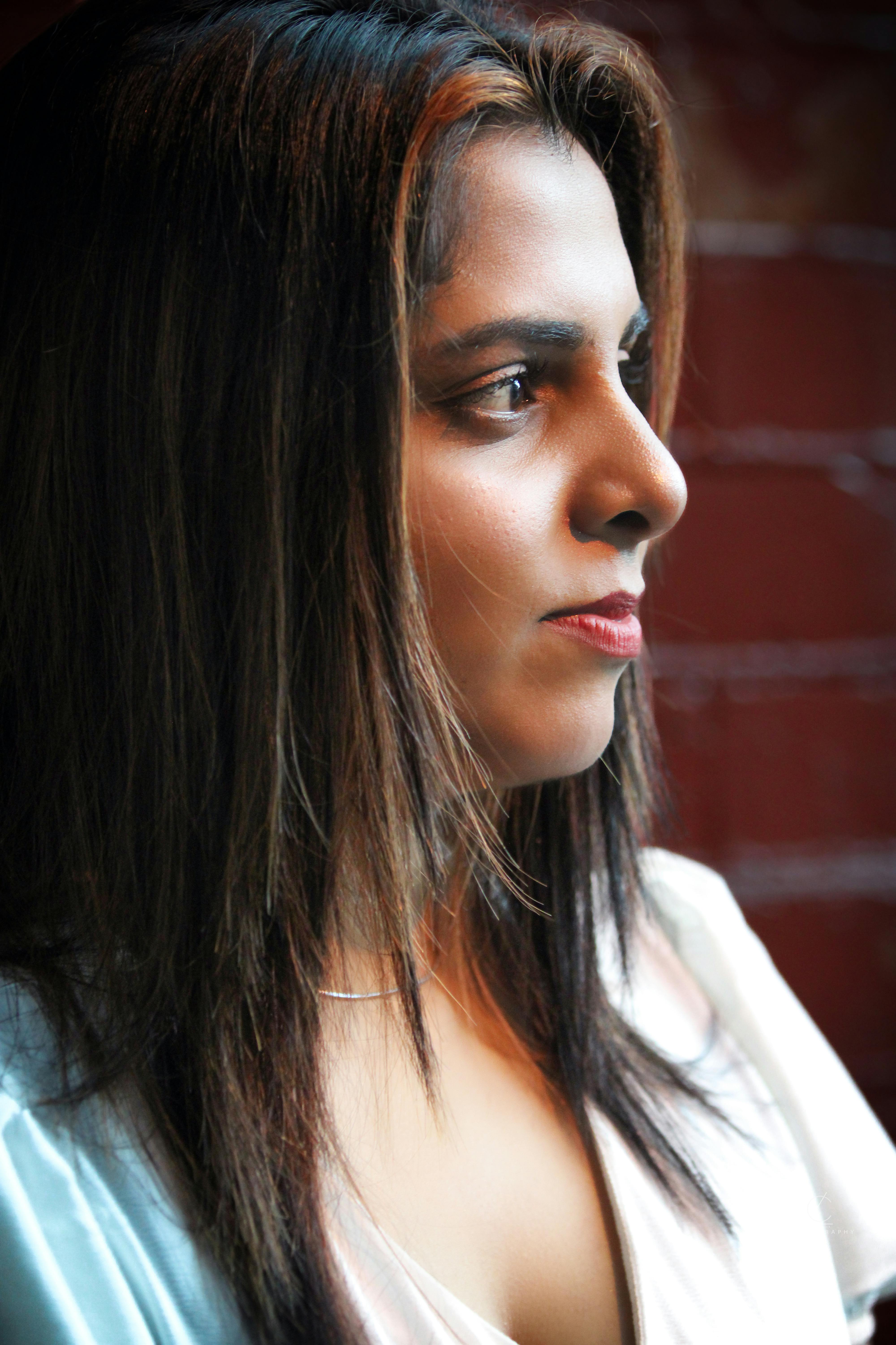 Elegant side profile portrait of a woman with artistic lighting.