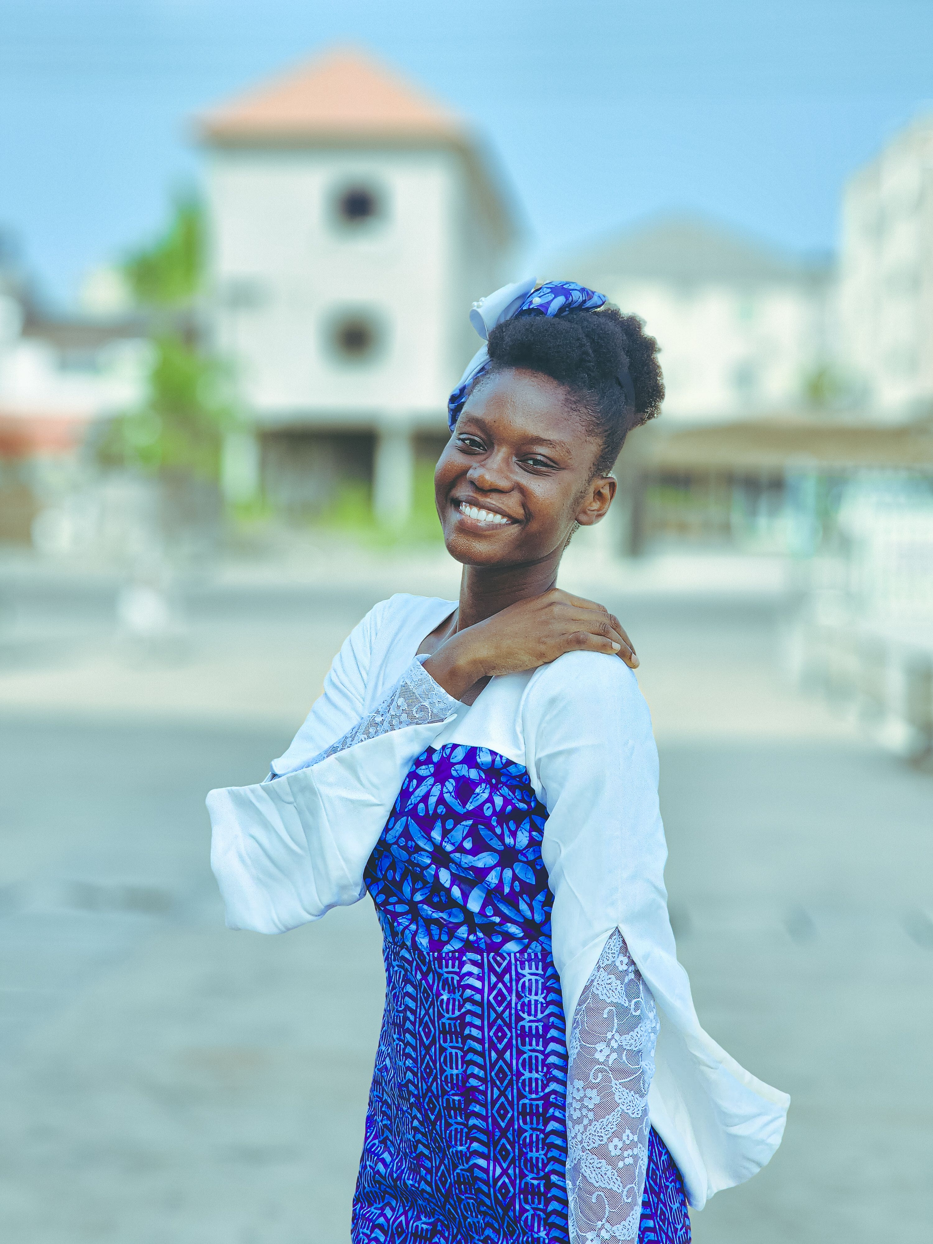 Smiling Woman in Blue and White Traditional Dress · Free Stock Photo