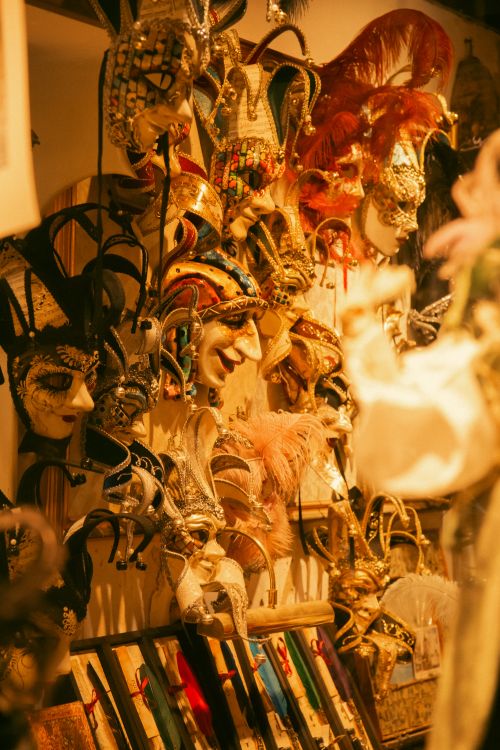 Free Colorful Venetian carnival masks on display in a shop in Venice, Italy, creating a festive atmosphere. Stock Photo