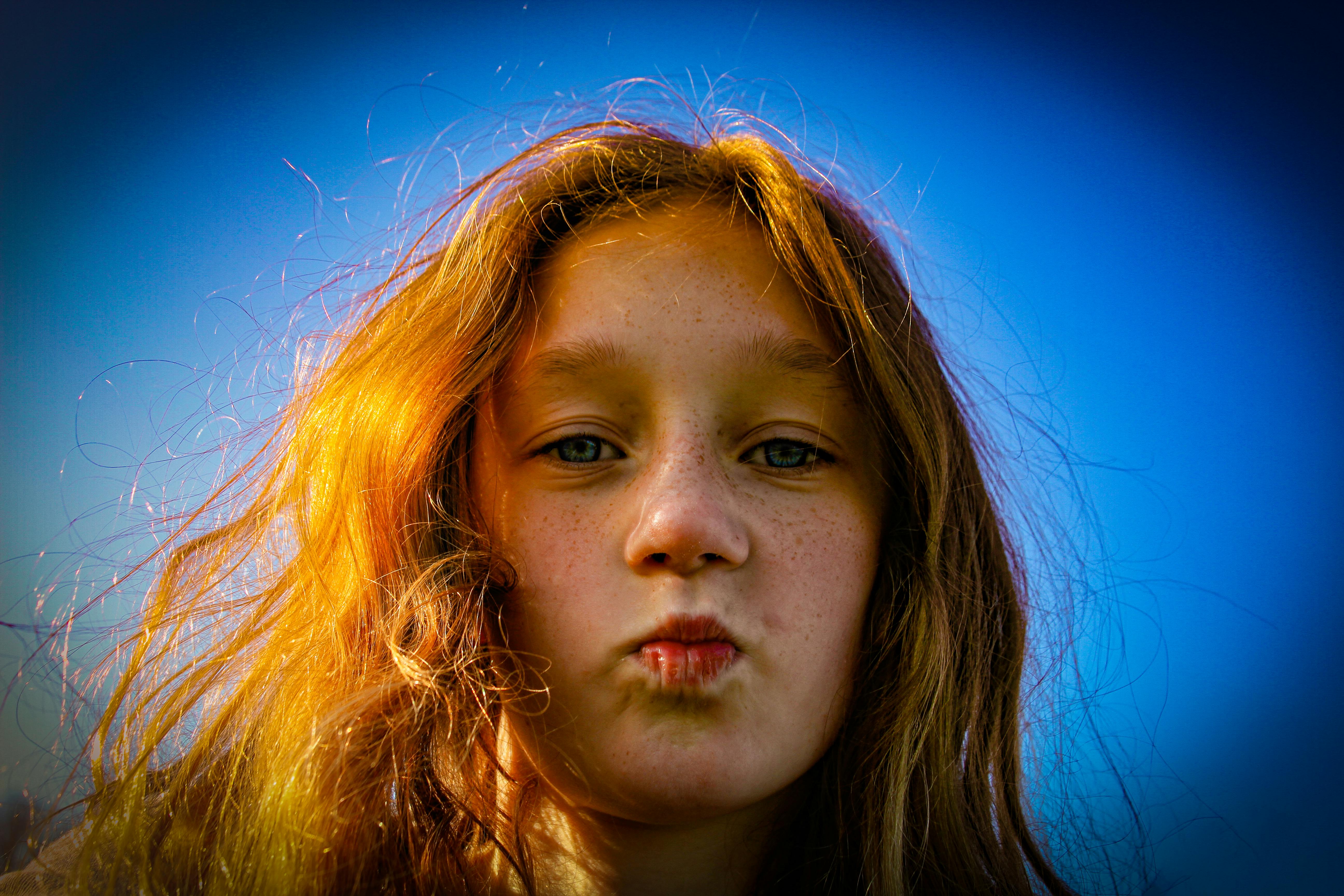 girl with red hair on blue background