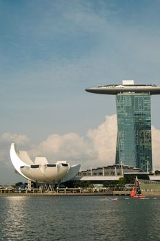 A daylight view of Marina Bay Sands and ArtScience Museum with a calm waterfront in Singapore.