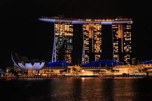 Iconic Marina Bay Sands lit up at night in Singapore, showcasing modern architecture.
