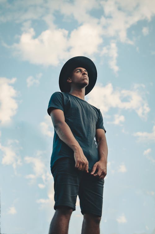 Low Angle Photo Man in Black T-shirt, Shorts and Fedora Hat