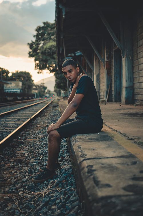 Free A man poses casually on a railway platform in Resende, Brazil during daytime. Stock Photo