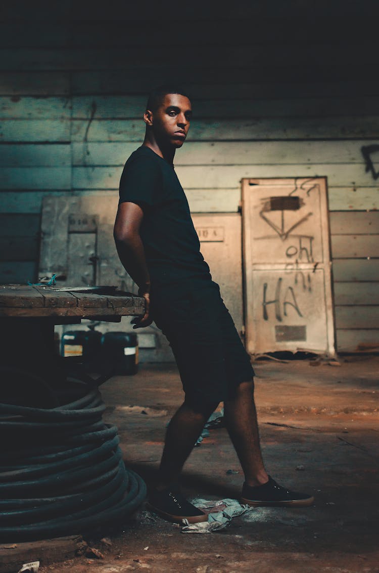 Man Leaning On Spool Table