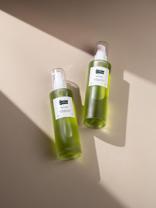 Free Stylish minimalist photo of green hair care bottles with natural lighting. Stock Photo
