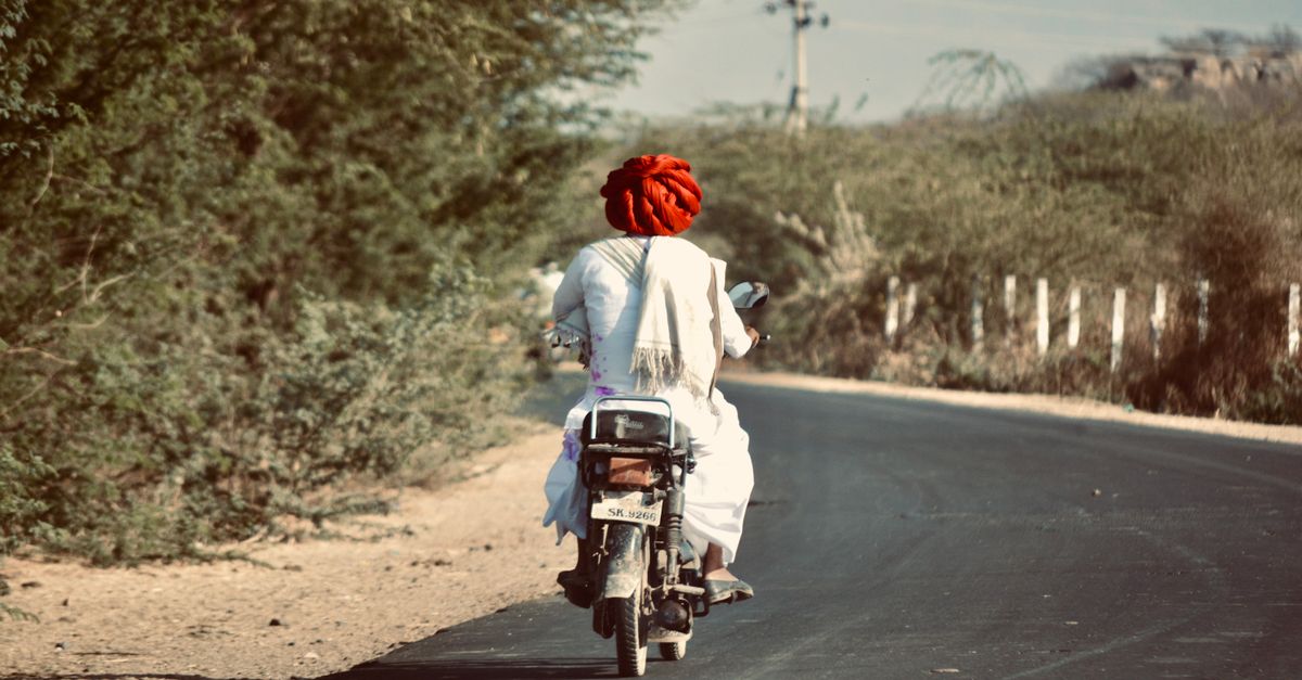 Rural Motorcycle Riding Rural Indian Man Riding Motorcycle on Desert Road · Free Stock Photo