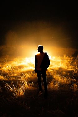 A lone figure silhouetted against backlit golden fields — photo by Hanifi Sarıkaya on Pexels