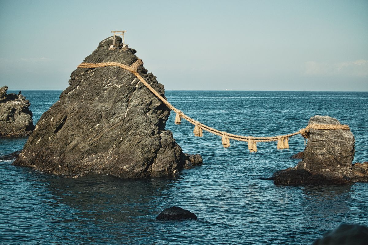 Meoto Iwa (Wedded Rocks) at Futami — two sea rocks bound by a shimenawa rope, a sacred site in Mie Prefecture on the approach to Ise Jingu